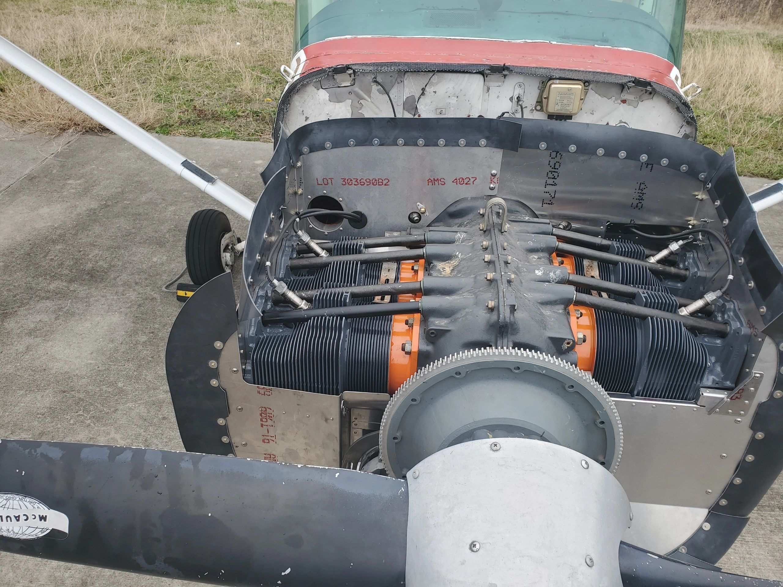 A Continental six-cylinder engine with the cowling off, on the ramp